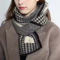 Detailed view of the women winter warm knitted houndstooth color blocked scarf texture. - 2