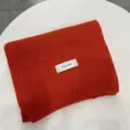 Cozy orange knitted winter scarf for women, warm Korean style solid color neck warmer detail shot. - Persimmon Red