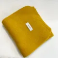 Detailed close-up view of the soft yellow knitted scarf showing texture and branding tag. - Yellow / 170cm