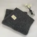 Dark grey thick knitted scarf detail showcasing soft fuzzy texture and cute woven label. - 220cm / Dark Gray