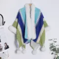 Colorful knit boho poncho with plush faux fur trim and playful pom pom for winter warmth. - Lake Blue