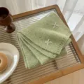Green wool blend knitted scarf featuring sweet white bow embroidery details, cozy and warm. - Matcha Green