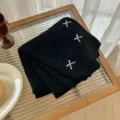 Black knitted scarf detail shot with white bow embroidery cozy winter warm accessory - Black