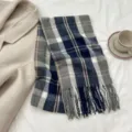 Close-up of stylish blue and grey plaid cashmere-feel scarf with fringe details and warm texture. - Size 10 / 180cm