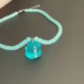 Close-up of the light blue beaded necklace featuring a cute ghost resin pendant detail. - Style 4 (Blue Translucent Ghost)