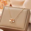 Elegant gold-toned multi-charm necklace featuring heart and letter pendants for women. - Letter S