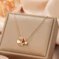 Gold-colored alloy letter M pendant necklace with cute heart and rhinestone charms for women. - Letter M