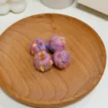 Close-up detail shot of colorful DIY knitted yarn balls, perfect for handmade jewelry accessories. - Pink Spotted Winding Ball