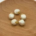 Fabric wrapped ball buttons with gold loops, detail view of DIY jewelry accessories. - Satin Beige