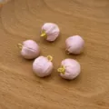 Close-up of pink fabric covered round beads with gold loops for DIY jewelry crafts. - Pink Satin Fabric