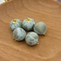 Detailed view of fabric wrapped DIY beads with gold loops, perfect for handmade jewelry. - Lace Green