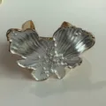 Close-up detail of luxury pearlized drop glaze flower jewelry cuff ring with gold trim. - Bracelet (3873)