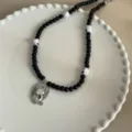 Detailgotische punk schedel hanger kraal ketting, zwarte kralen en witte schedel bedels voor vrouwen. - Gevleugelde Schedel Schijf Stijl (09)