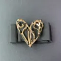 French retro exaggerated hollow heart metal buckle black elastic waist belt detail closeup. - Gold