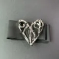 Close-up of the silver metal abstract heart buckle with black rhinestones on elastic belt. - Silver