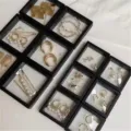Floating jewelry display box set with various earrings, rings, and hair accessories. - 7x9cm Transparent Box