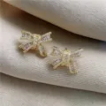 Exquisite sparkling crystal bow stud earrings crafted with premium zirconia stones. - Bowknot Stud Earrings / Gold