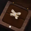 Exquisite gold-plated zircon bow ring featuring sparkling baguette and round stones for women. - Bow Knot Ring / Gold