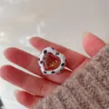 Detail shot of a chic heart-shaped pink crystal ring with cute black and white cow print enamel. - Heart Pink Diamond
