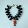 Collier ras du cou tendance avec perles en acrylique noir et pendentif homard rouge. - Noir