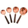 Stainless steel measuring cups set with wooden handles, rose gold finish, baking tools. - Four-Piece Set