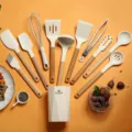 Detailed view of the silicone kitchen utensil set with wooden handles, neatly arranged. - Colander Wooden Handle 12-Piece Set