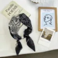 Detail view of the paisley silk scarf featuring a pearl buckle and stylish black white design. - One Size / 06#-Black Beige