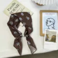 Brown floral small square silk scarf detail view with elegant pearl buckle accessory. - Small Floral