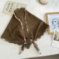 Detailed view of the brown hollow-out triangle scarf with chic plaid border for summer style. - Coffee