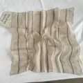 Close-up detail of vintage striped linen square scarf, relaxed style, neutral tone, soft texture. - Linen Striped