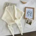 Detail view of a cream white knit hollow triangle scarf shawl, cozy neck warmer for autumn winter. - 130x24cm / White