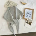 Close up detail of grey knitted triangular scarf, soft and warm neck warmer for daily wear. - 130x24cm / Gray