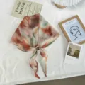 Elegant women's printed silk scarf with center bead, lightweight summer triangle neckerchief. - One Size / Extra Long / Brown Red