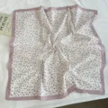 Detail shot of floral cotton square scarf, soft pink border and paisley pattern, elegant style. - Taro