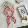 Detailed view of a chic pink polka dot slim silk scarf featuring an elegant faux pearl ring. - One Size (49cmx7cm) / Rose Pink