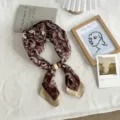 Detailed view of brown paisley silk scarf with wooden ring accessory on white fabric. - 50*14cm / 03#-Coffee Paisley