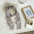Gros plan d'un foulard étroit à rayures chic dans un décor esthétique et chaleureux. - 03#-Foulard Rayé / Taille unique