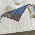 Detailed view of vintage ethnic print triangular scarf with white fringes and ties. - One Size / Blue