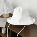 White wide brim bucket hat with chin strap, textured fabric, stylish summer sun protection hat. - One Size / White
