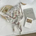 Detail view of lightweight abstract print triangular scarf, elegant summer sun protection wrap. - 110*30cm / Coffee