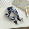 Primo piano dettagliato di un piccolo fazzoletto quadrato in cotone tie-dye blu e bianco. - 55x55cm / Fiore