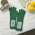 Detailed view of women long knit gloves with delicate white lace trim, cozy autumn winter wear. - 29*8.5cm / Green