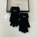 Detail shot of black knit gloves featuring cute puppy embroidery on the cozy foldover cuff. - One Size / Black