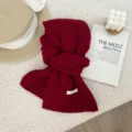 Detail view of soft red knitted wool scarf featuring delicate plaid texture and cozy warm feel. - 146x22cm / Burgundy