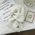 Detailed view of white knitted scarf with embroidered horse design, soft and warm texture. - 170*24cm / White