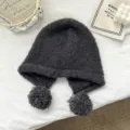 Close-up detail of cozy wool winter balaclava hat with cute pom poms in dark gray color. - One Size / Dark Gray