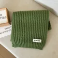 Close-up detail of green knitted winter scarf, soft texture and simple daily warm neckerchief. - Green