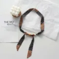 Close-up detail of a floral fabric ribbon necklace featuring decorative wooden beads. - Vintage Floral (04#) / 45x2.5cm