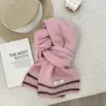 Cozy pink wool scarf detail featuring charming brown stripes and 100% wool label texture. - 160x21cm / Pink