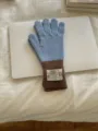 Detailed view of women winter knit gloves with blue and brown color blocking and ribbed cuffs. - One Size / Blue Coffee